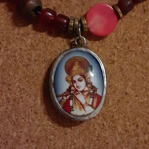 Red beaded necklace with Lord Krishna charm